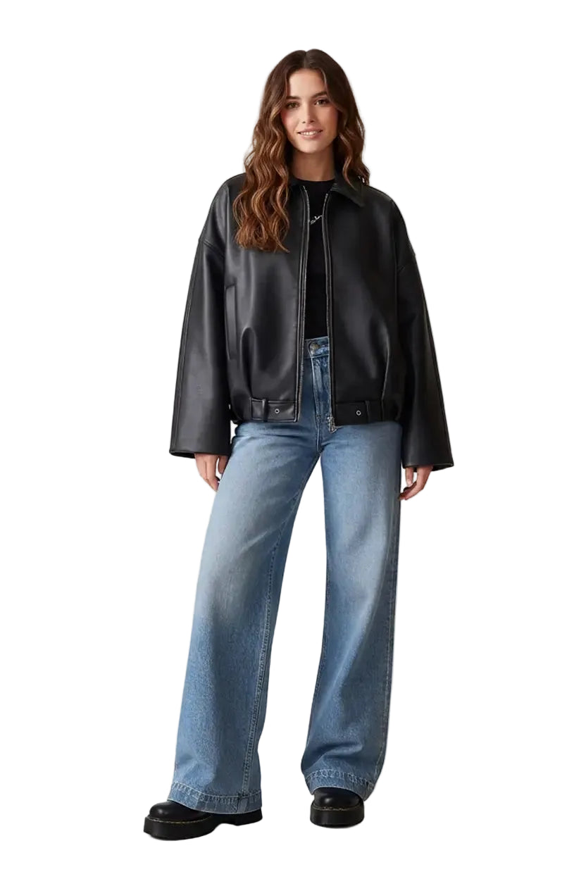 Woman wearing a black leather jacket and blue jeans on a white background